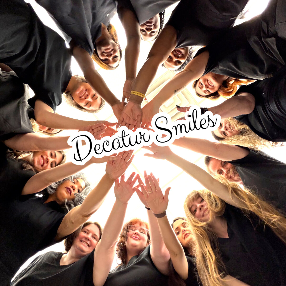 Decatur Smiles team — hands in the middle